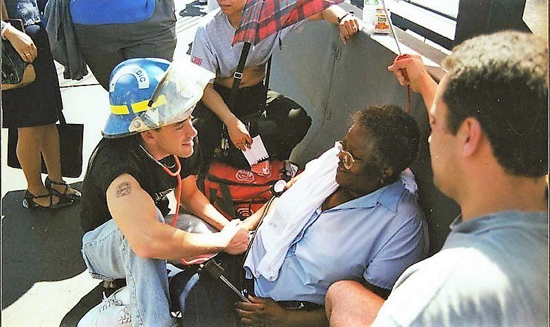 A woman in a hard hat is sitting on the bus