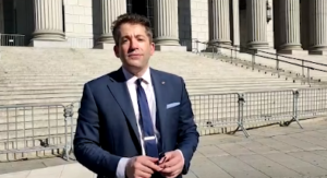 Man in suit standing before courthouse steps