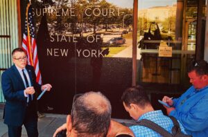 Lawyer briefing reporters outside New York Supreme Court