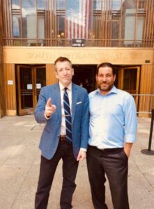 Two men posing outside South Entrance Hall