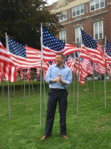 Smiling person among American flags
